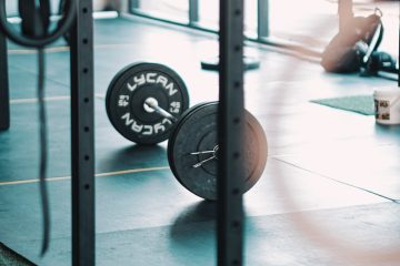 a gym with a barbell and weight plates